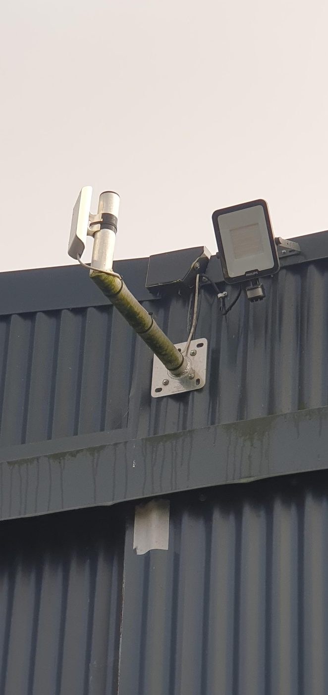 Antenna and floodlight on a steel shed