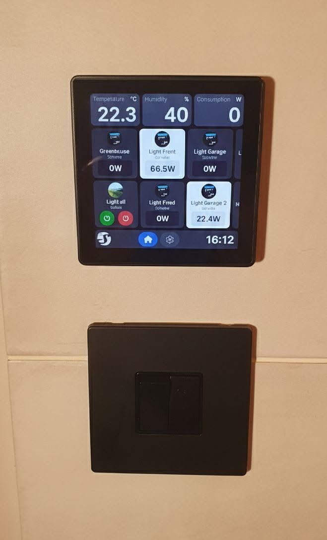 Smart home wall display above a light switch showing temperature and lights