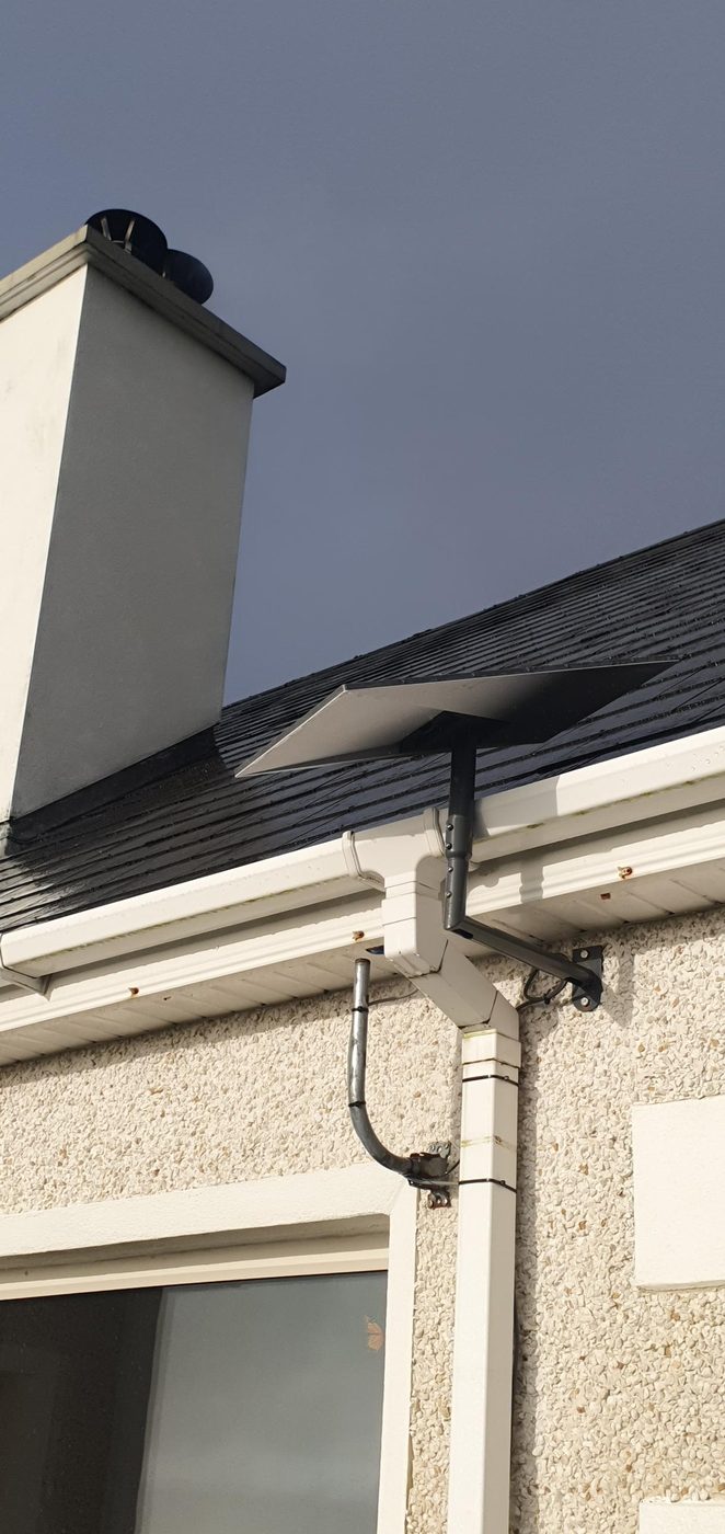 Starlink on a wall arm beside a chimney